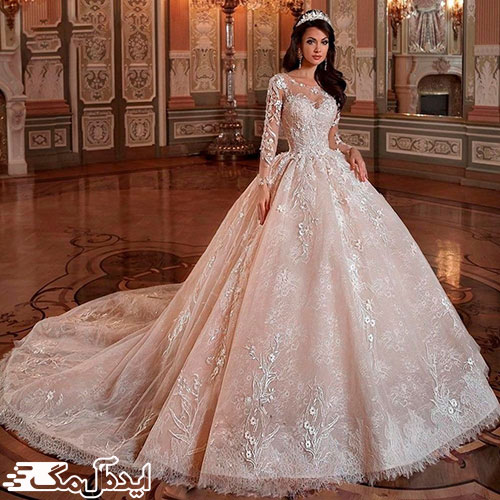 یک مدل زیبای لباس عروس پرنسسی با دنباله و آستین و تور دانتل حاشیه‌دار 