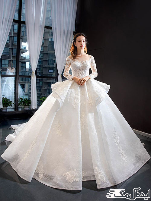 یک مدل لباس عروس آستین‌دار پفی زیبا با طراحی دامن دو لایه