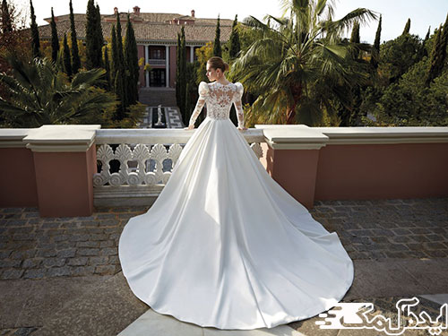 مدلی زیبا از لباس عروس پشت بلند با بالاتنه گیپور و آستین‌های بلند