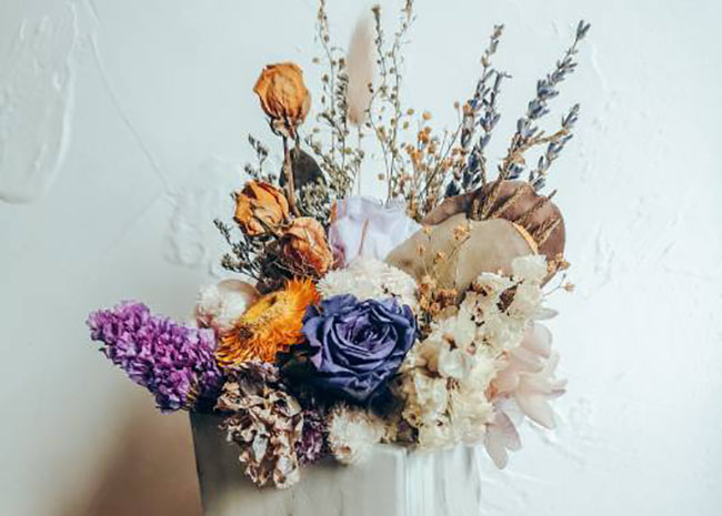 یک دسته گل رنگی توی یک گلدان سفید